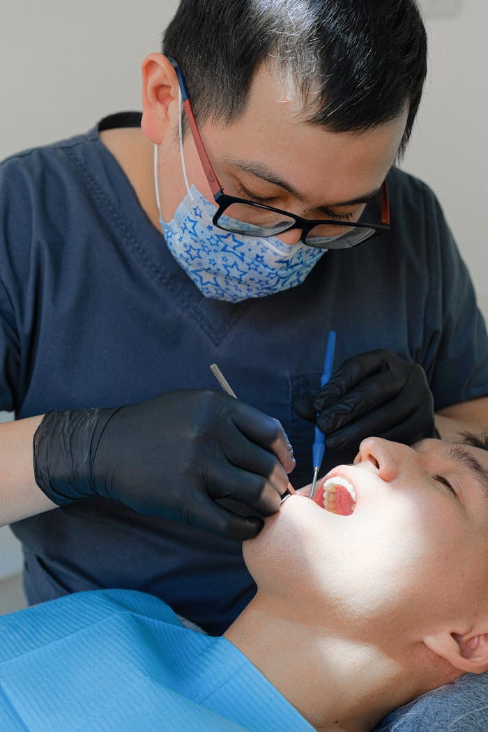 Dentist performs a dental exam on patient using advanced tools in a clinic.